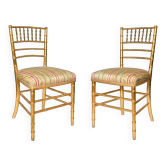 Pair of golden wood chairs in a bamboo style.