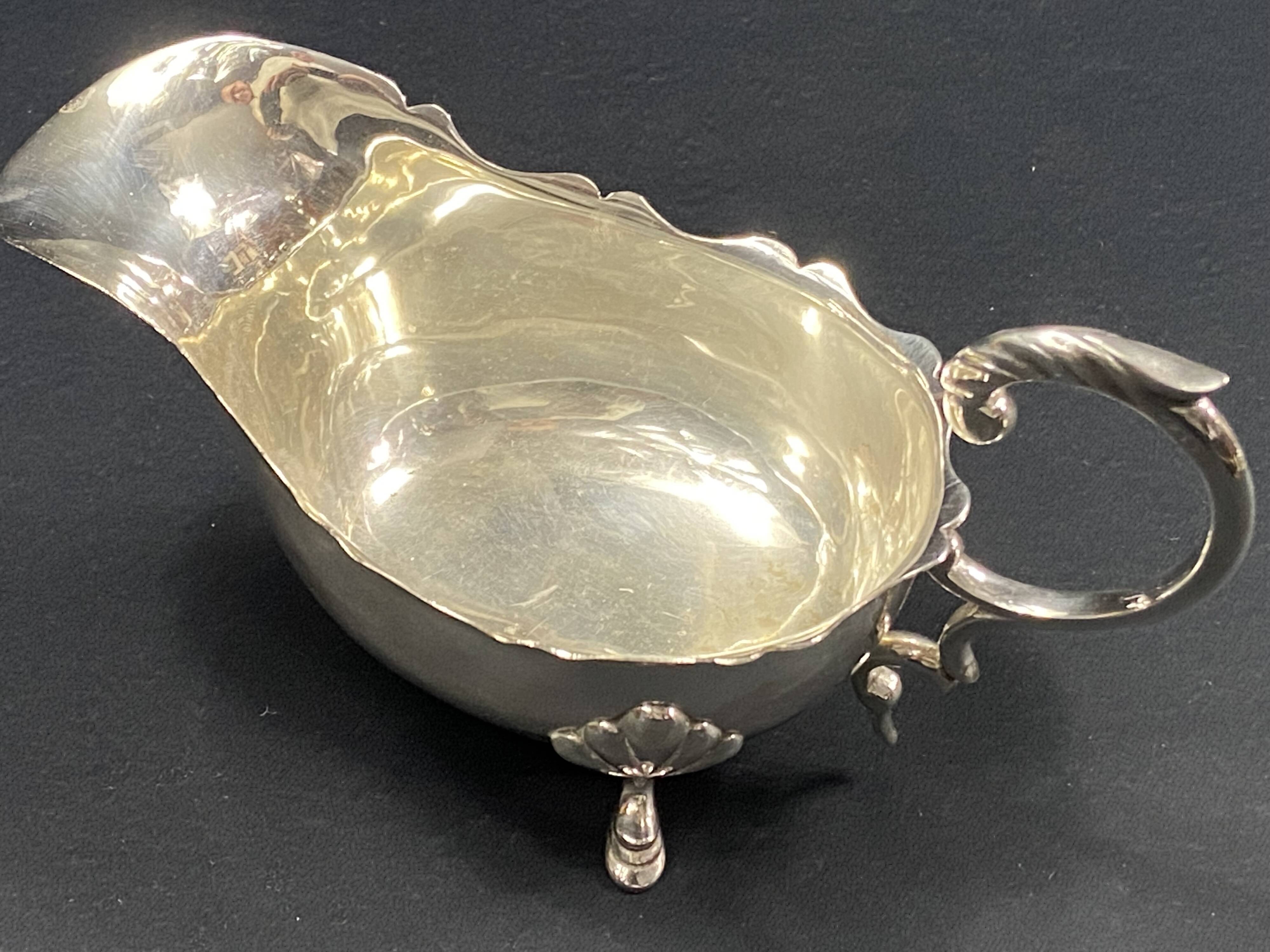English George III style silver plated tripod sauce boat