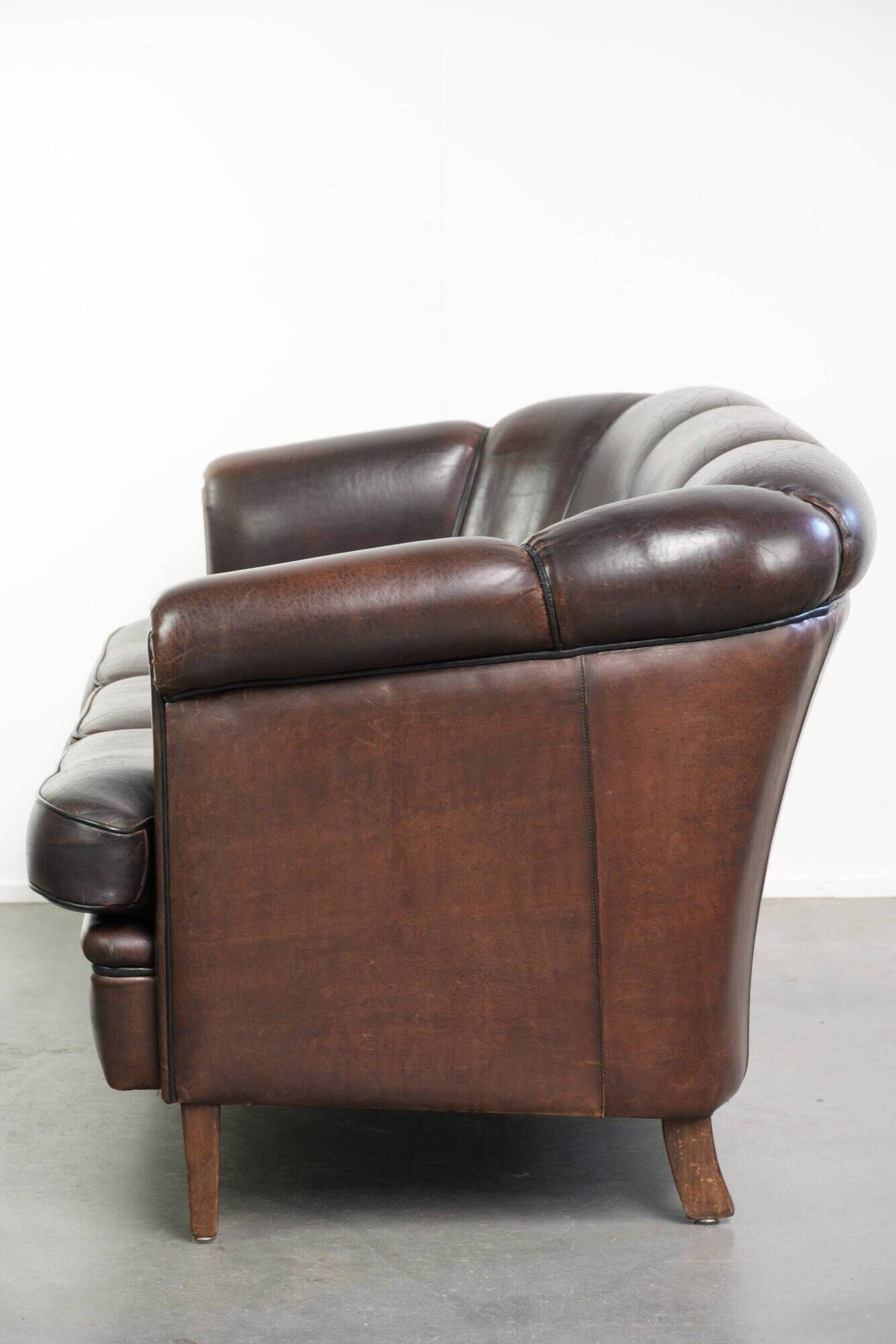 Set of a sheepskin sofa together with its matching club armchair
