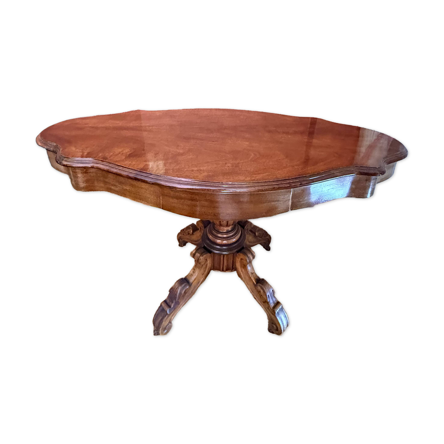 Antique mahogany table with a scalloped top and a sculpted central leg.