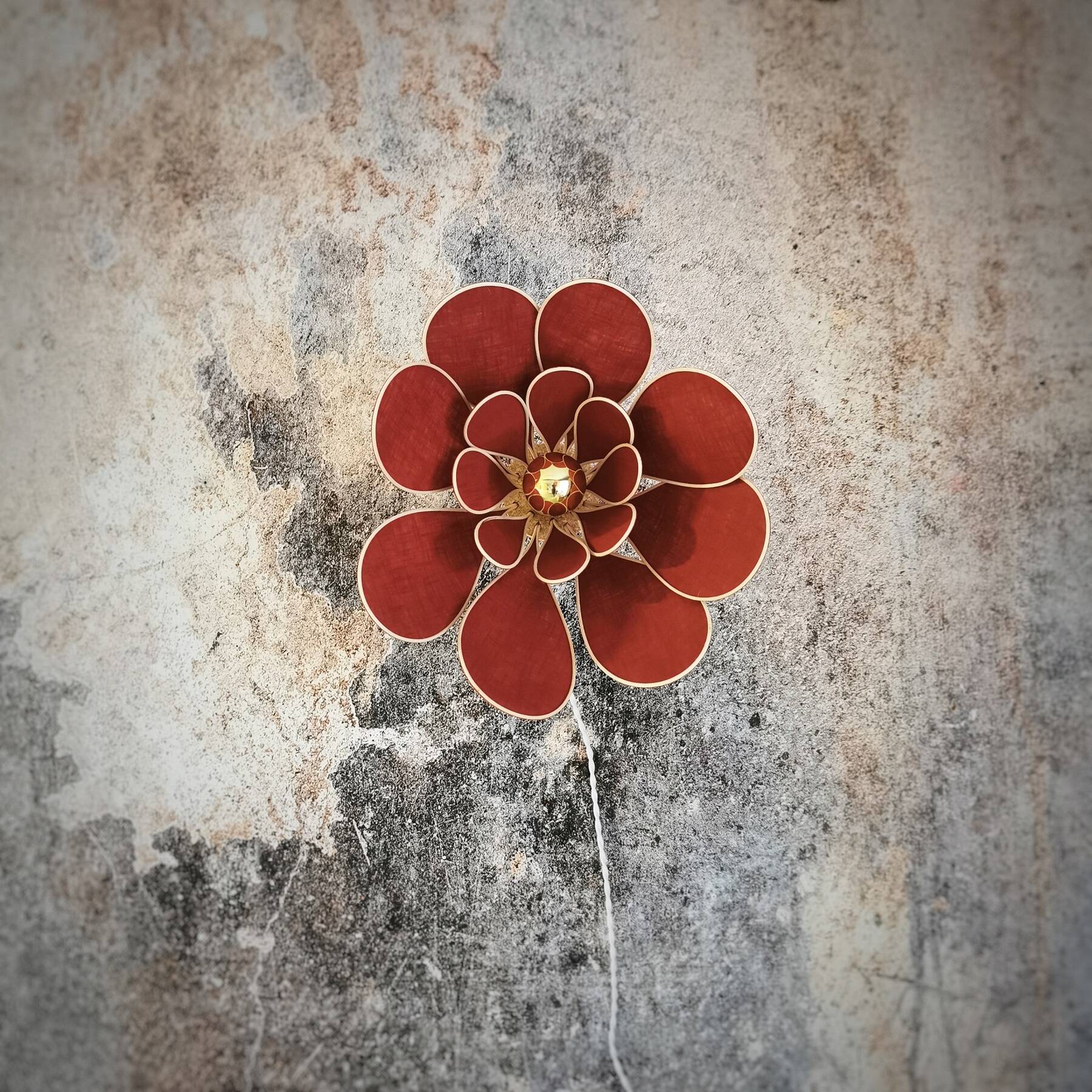 Flower wall light made of rattan and terracotta linen petals