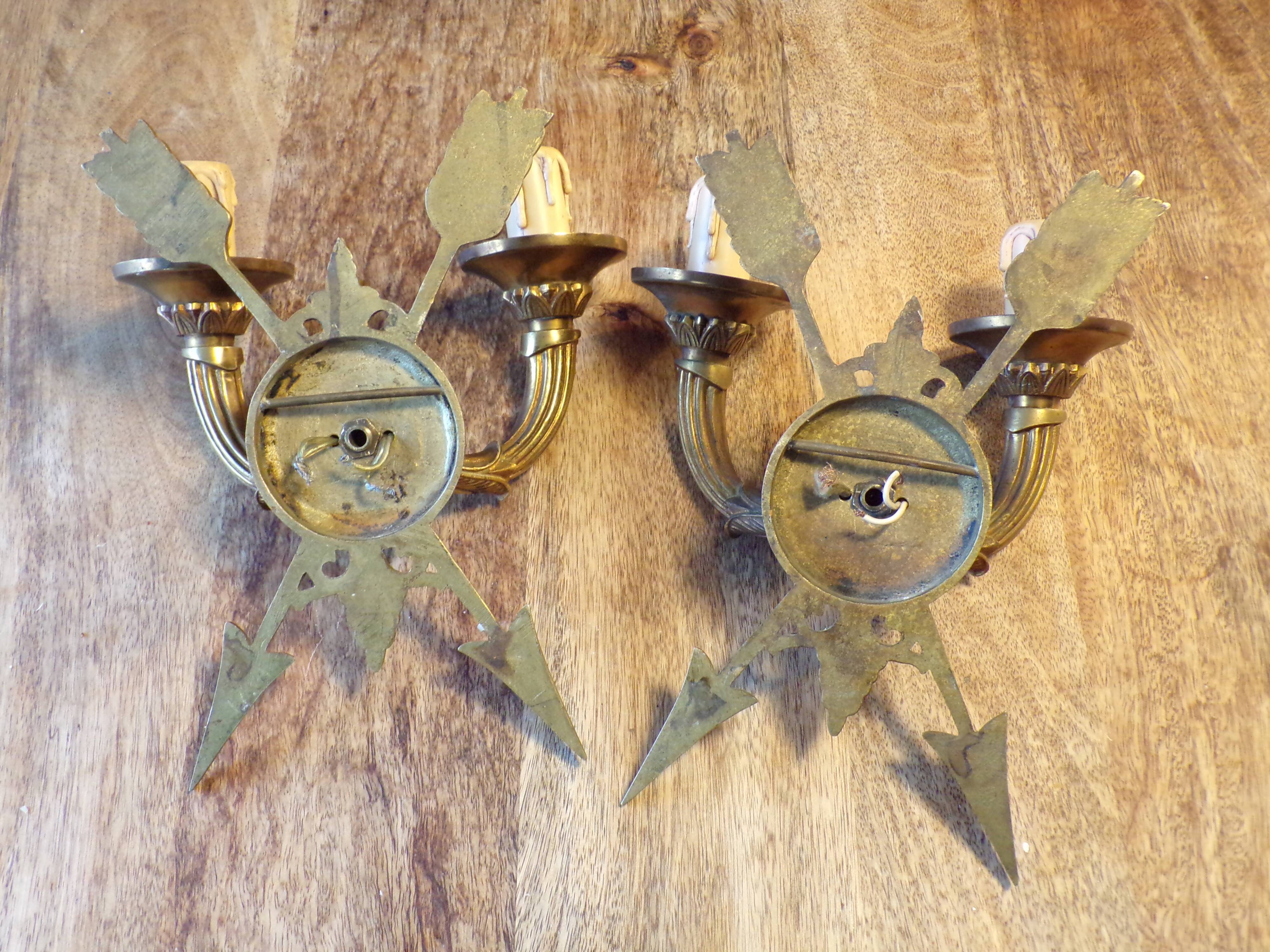 Pair of empire style bronze arrow wall lights