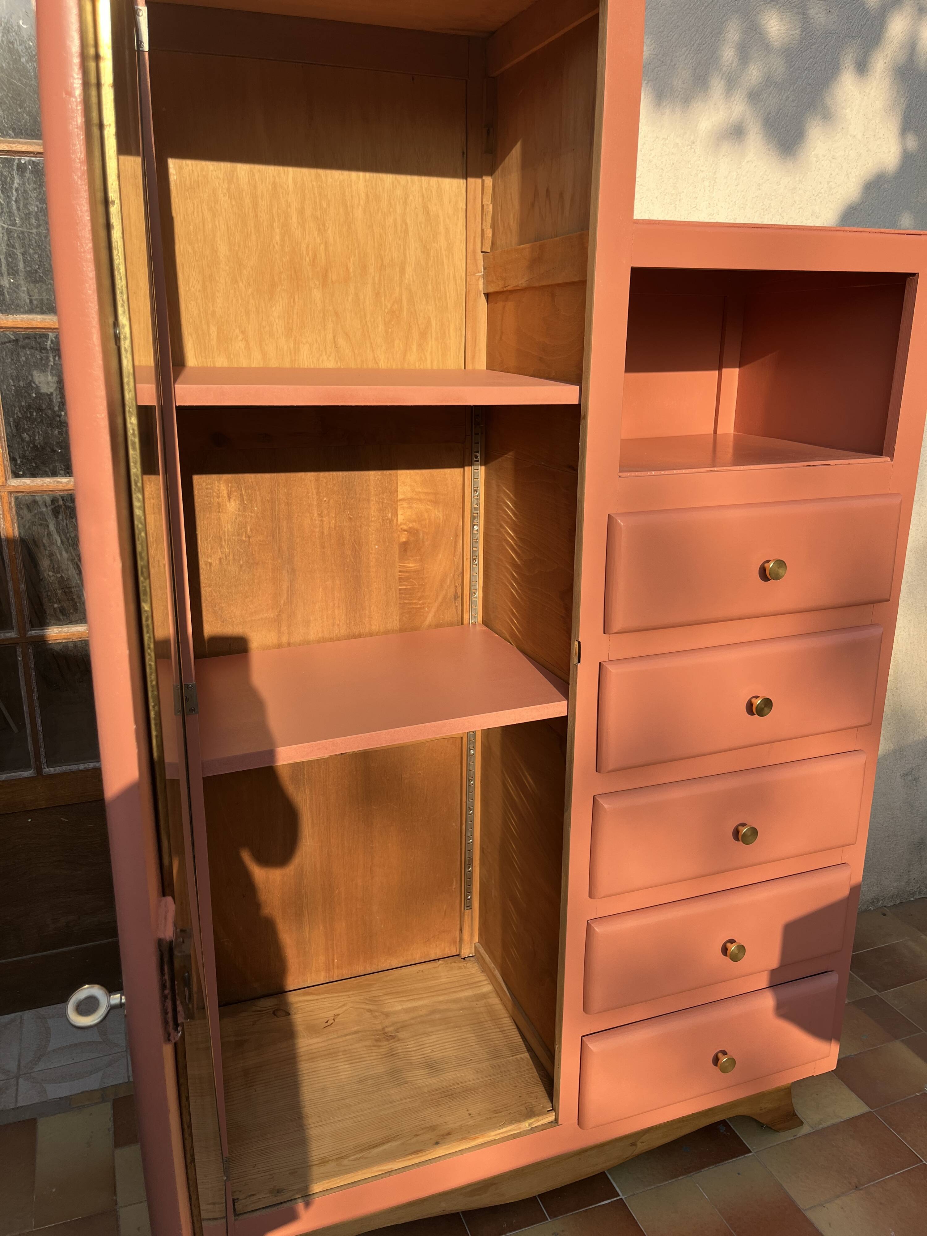Asymmetrical vintage wardrobe painted in terracotta.