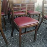 Set of 8 bistro chairs in vintage red wood and leatherette.