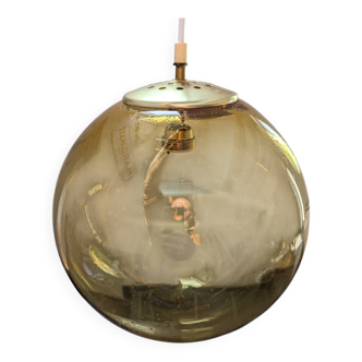 Old large and imposing thick glass globe with a bubbled amber colour, vintage.