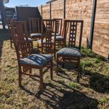 Set of 8 teak lounge chairs with high backs and zebra-striped seats