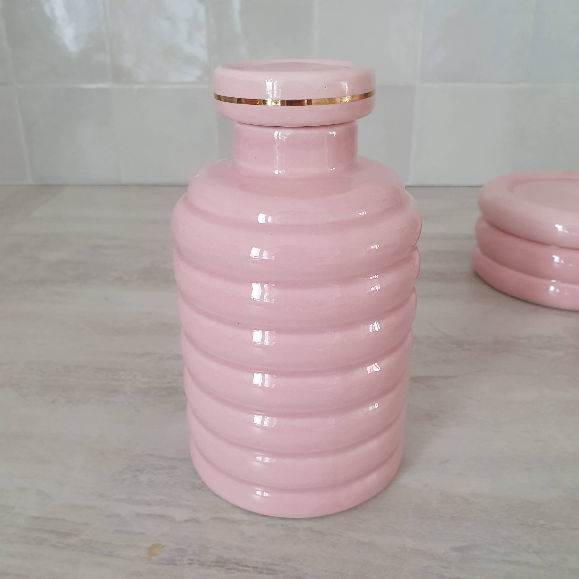 Set of pink and gold ceramic bathroom accessories