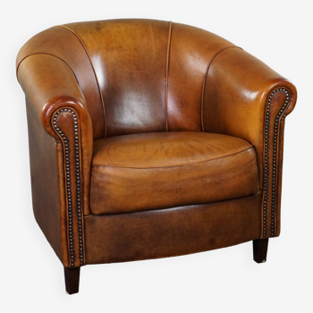 Sheepskin club armchair with a fixed seat cushion