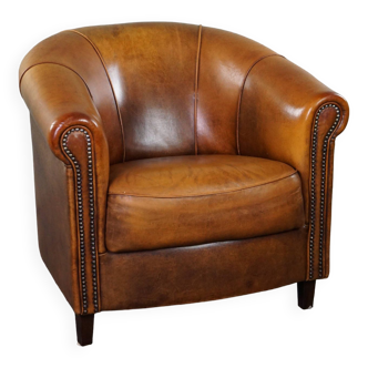 Sheepskin club armchair with a fixed seat cushion