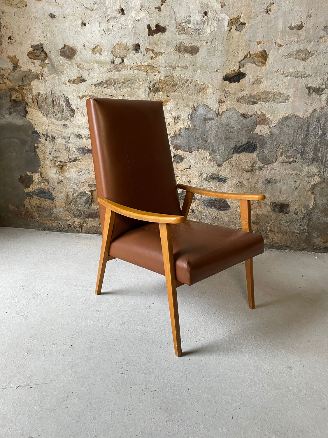 Vintage armchair in wood and brown faux leather
