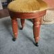 Upholstered stool on casters