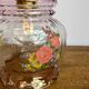 Vintage pink glass hand lamp with flower motifs