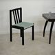 Set of 6 modernist black chairs with light blue-green ribbed fabric.