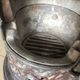 Old compact wood stove in enamelled cast iron with tripod feet with Lion's legs
