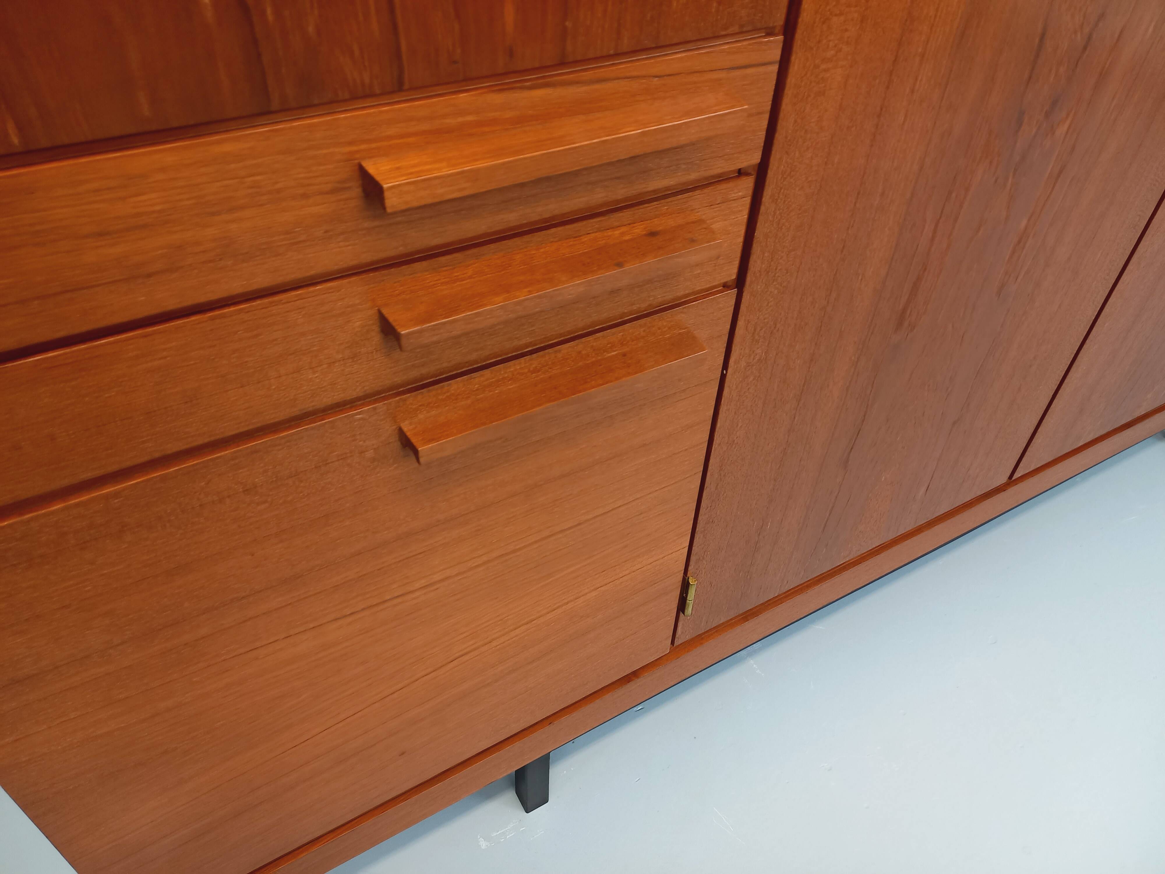 High Scandinavian modernist vintage sideboard in teak and black metal.