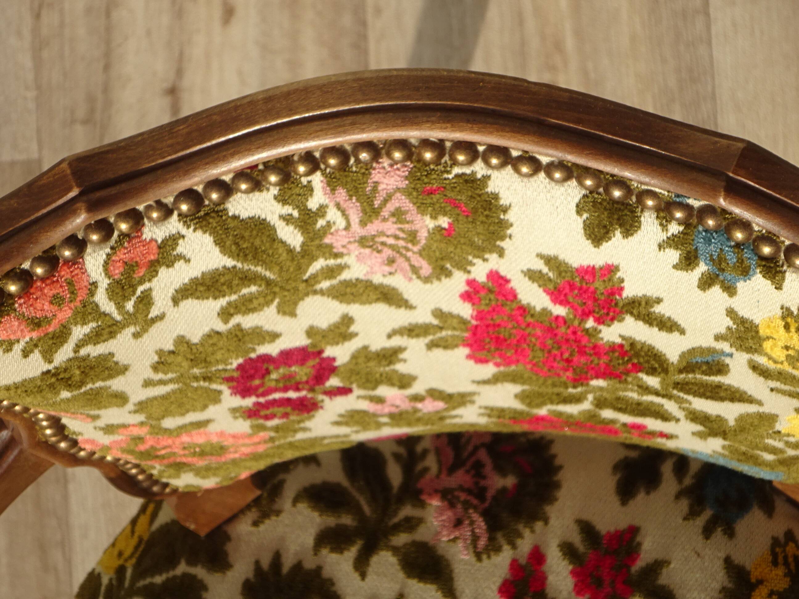 Convertible armchair with brocade fabric and floral patterns.