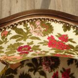 Convertible armchair with brocade fabric and floral patterns.