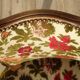 Convertible armchair with brocade fabric and floral patterns.