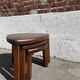 Nested tripod tables made of solid wood, in a modernist brutalist style.