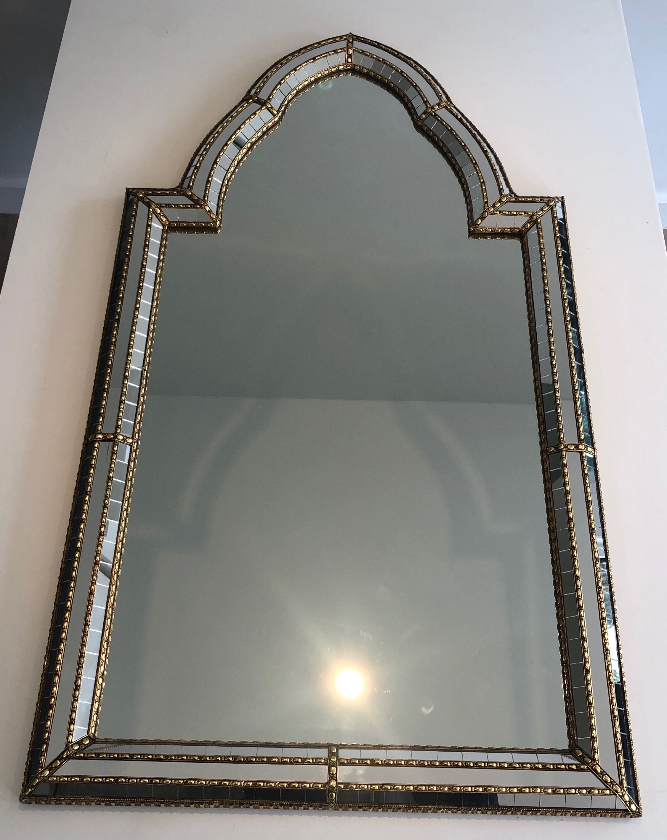 Mirror consisting of multi-faceted mirrors and brass garlands, French work, around 1970