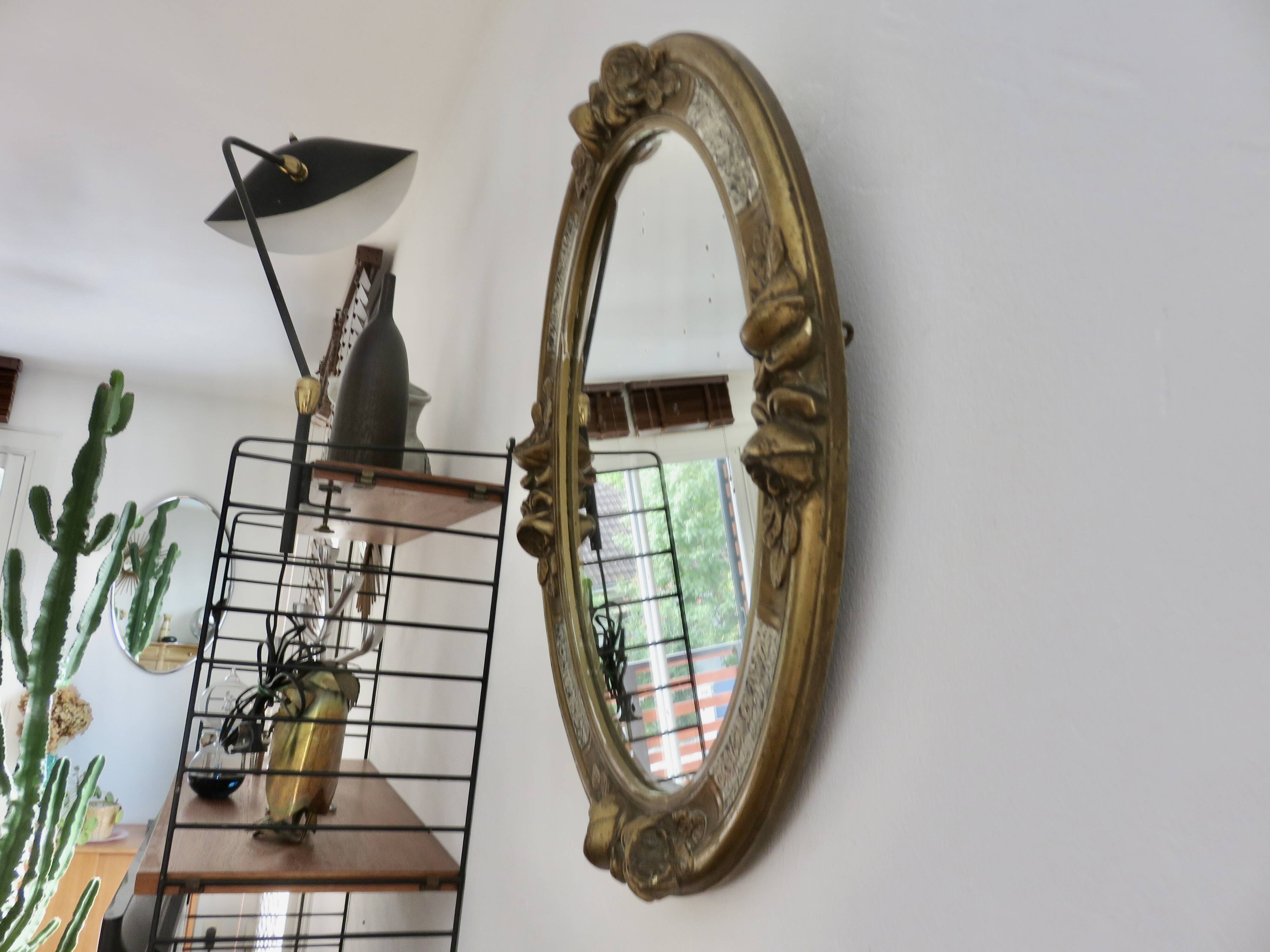 Oval wall mirror, golden floral pattern in stucco and wood, late 19th century