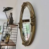Oval wall mirror, golden floral pattern in stucco and wood, late 19th century