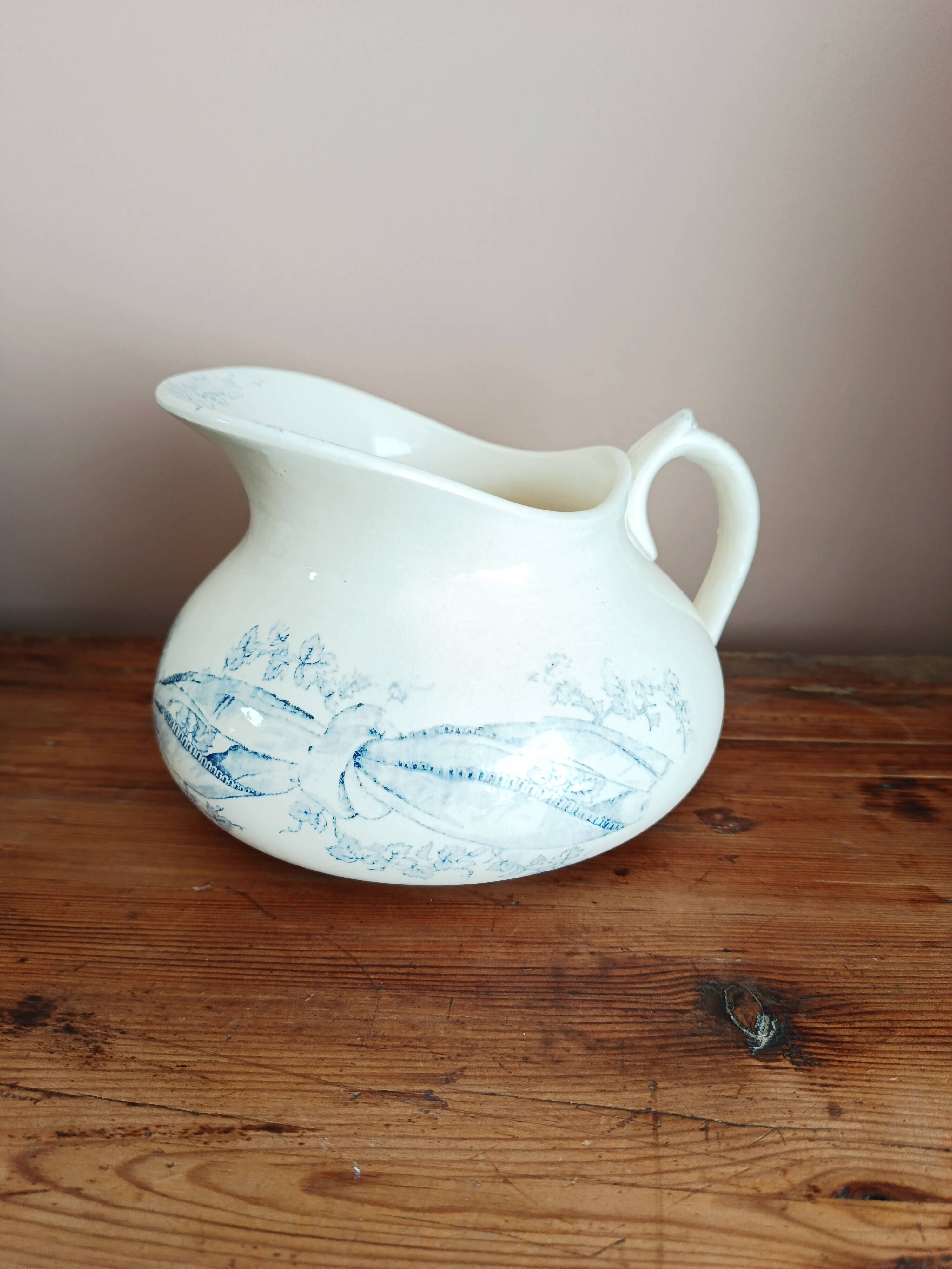 Old bulbous jug in ironstone earthenware