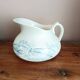 Old bulbous jug in ironstone earthenware