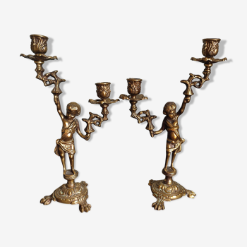 Pair of antique candlesticks in cherub bronze