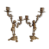 Pair of antique candlesticks in cherub bronze