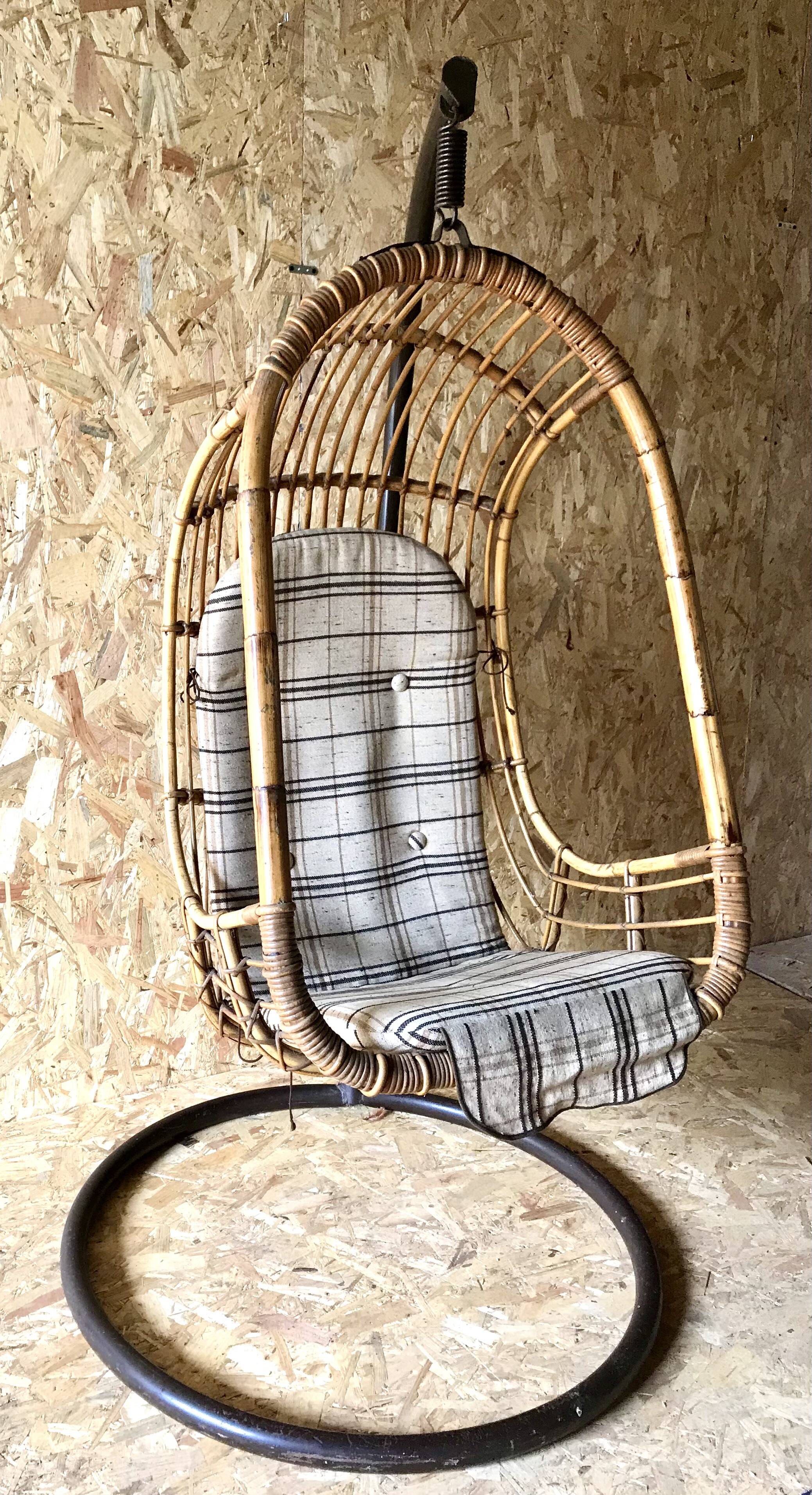 Vintage rattan hanging chair with its stand.