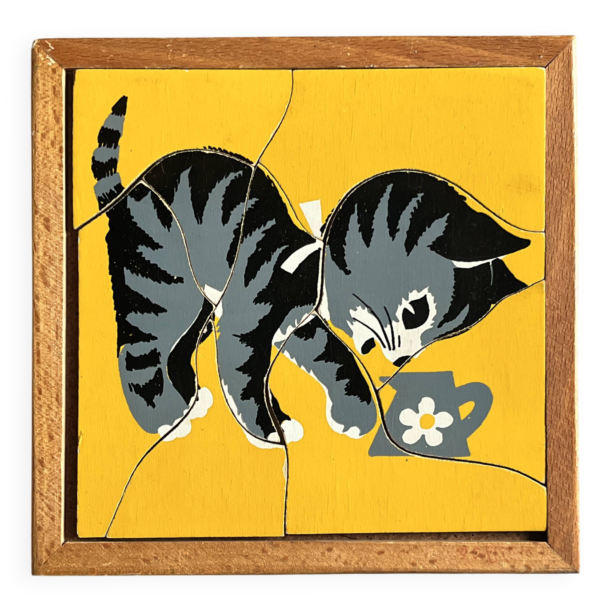 Wooden frame puzzle from the 1940s/50s depicting a cat on a yellow background.
