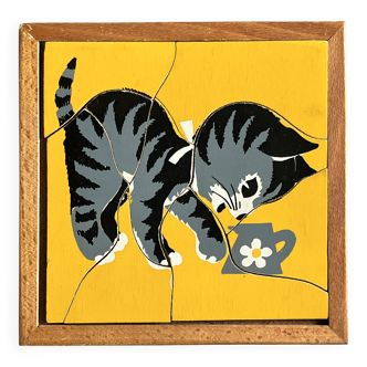 Wooden frame puzzle from the 1940s/50s depicting a cat on a yellow background.