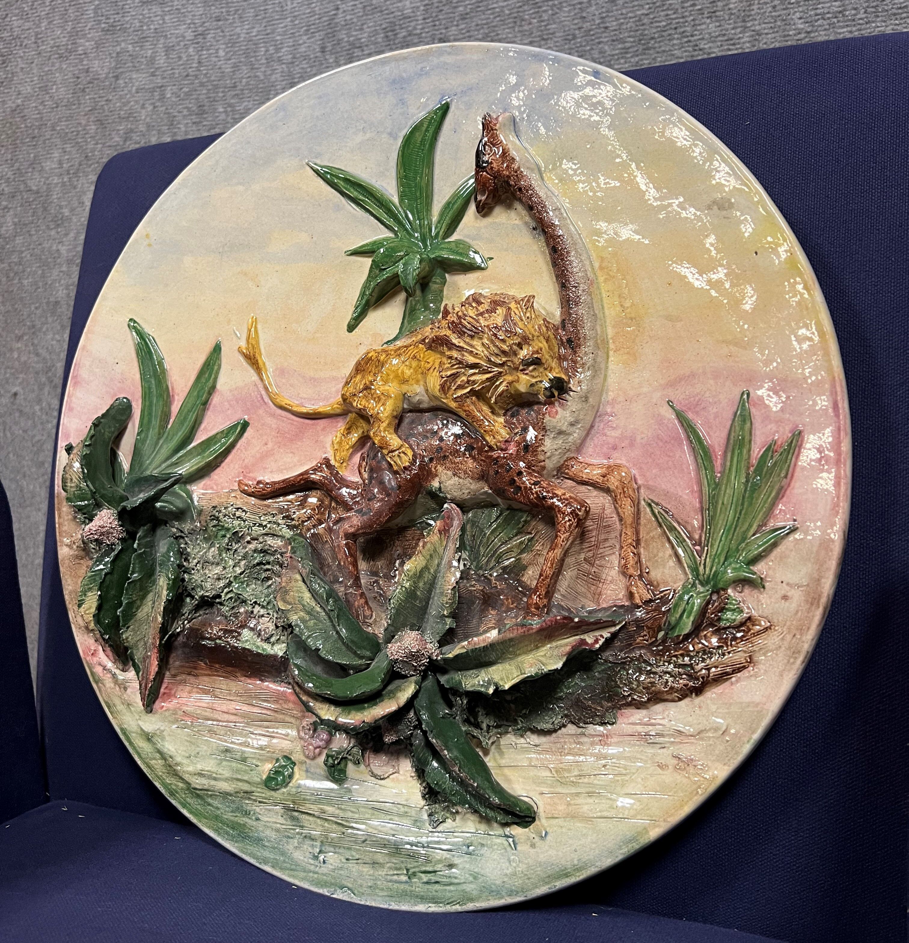 Ceramic dish depicting a lion attacking a giraffe