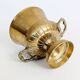Vintage brass cache-pot on a stand with handles, classic decor.