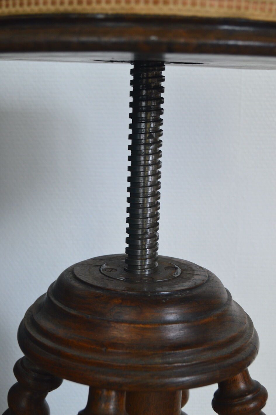 Antique piano stool with adjustable screws and turned wooden legs