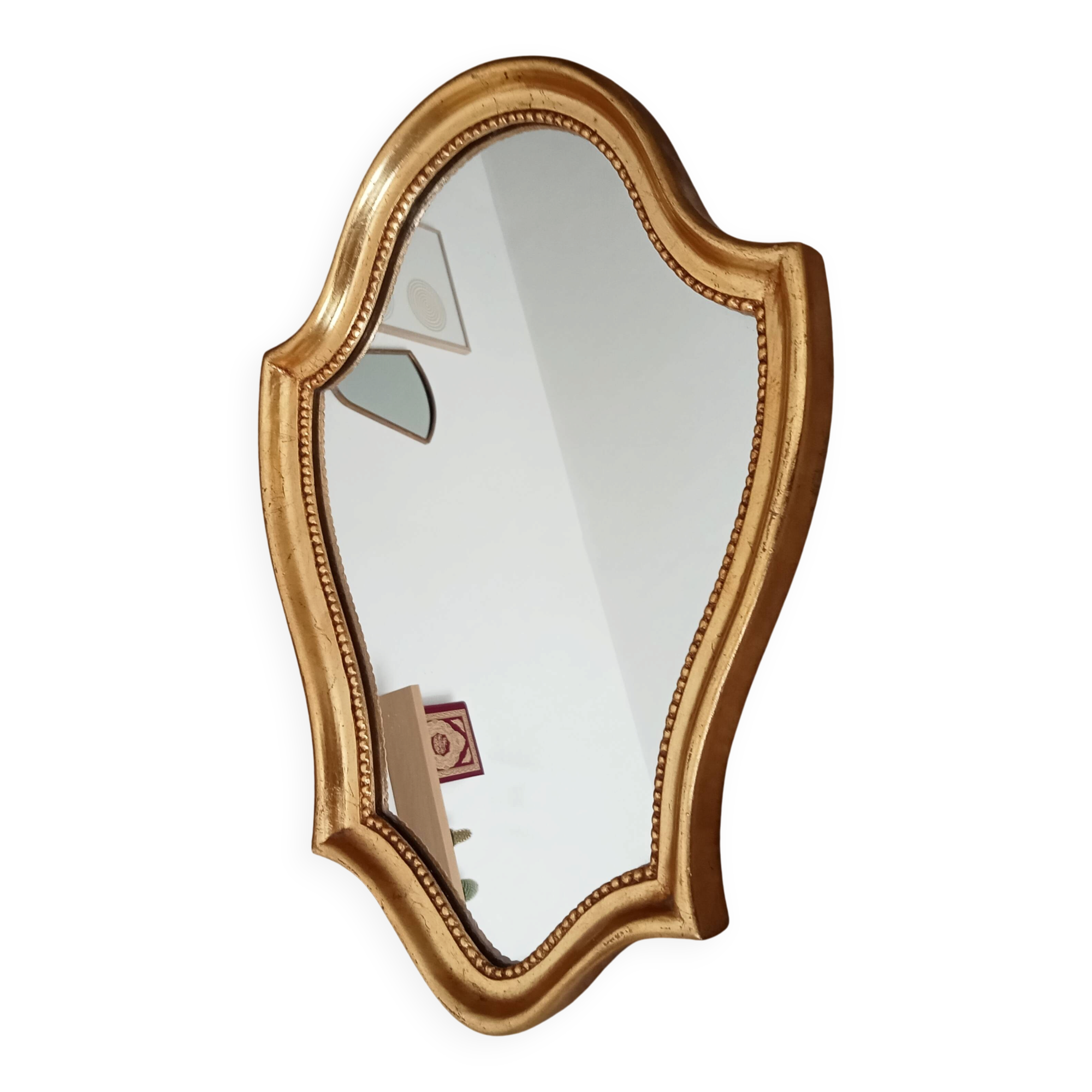 Vintage baroque mirror in gilded wood in the Louis XV style.