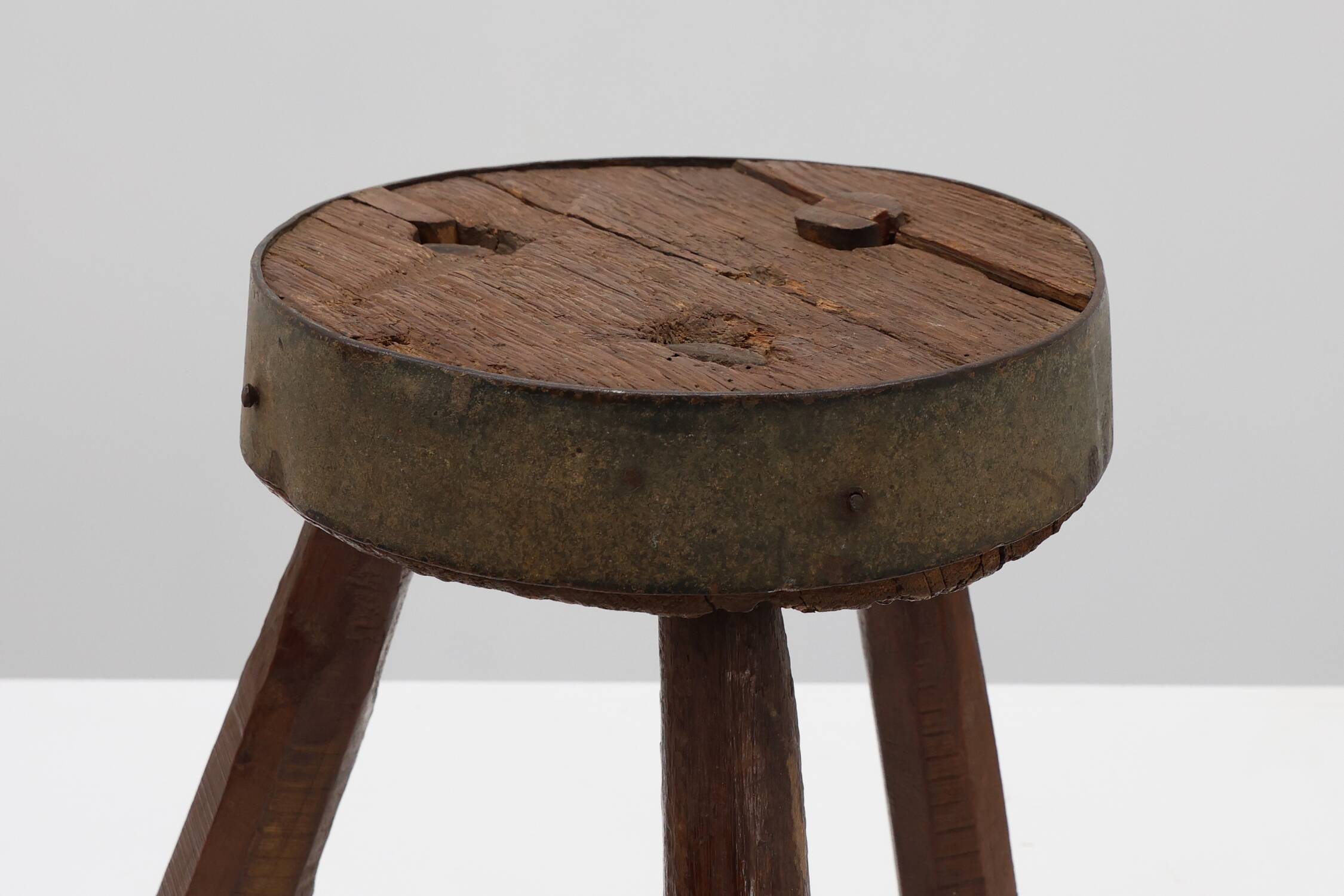 Brutalist French solid oak tripod stool with metal rim, 1850s