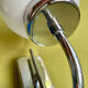 Pair of chrome metal wall lights with white glass globe.