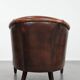 Club chair made of sheepskin leather finished with decorative nails