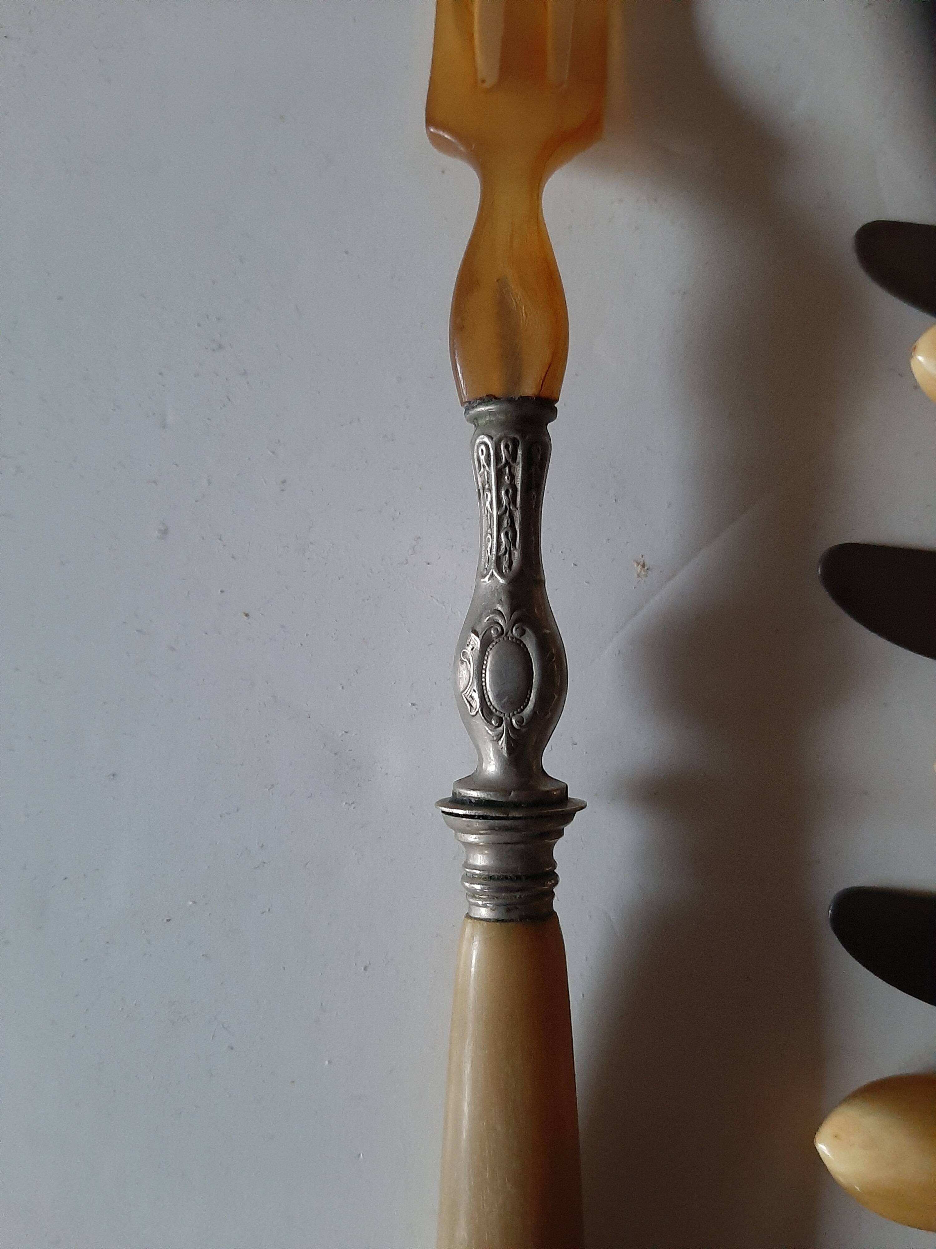 29-piece horn cutlery set, knives and serving utensils.