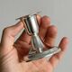 A pair of small silver-white metal candle holders.