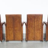 Vintage set of 4 sheepskin leather dining chairs on castors