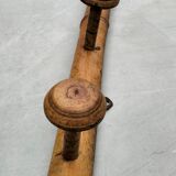 Old rustic wooden coat rack turned in imitation of bamboo