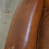 Beautiful and comfortable sheepskin armchair, finished with decorative nailheads