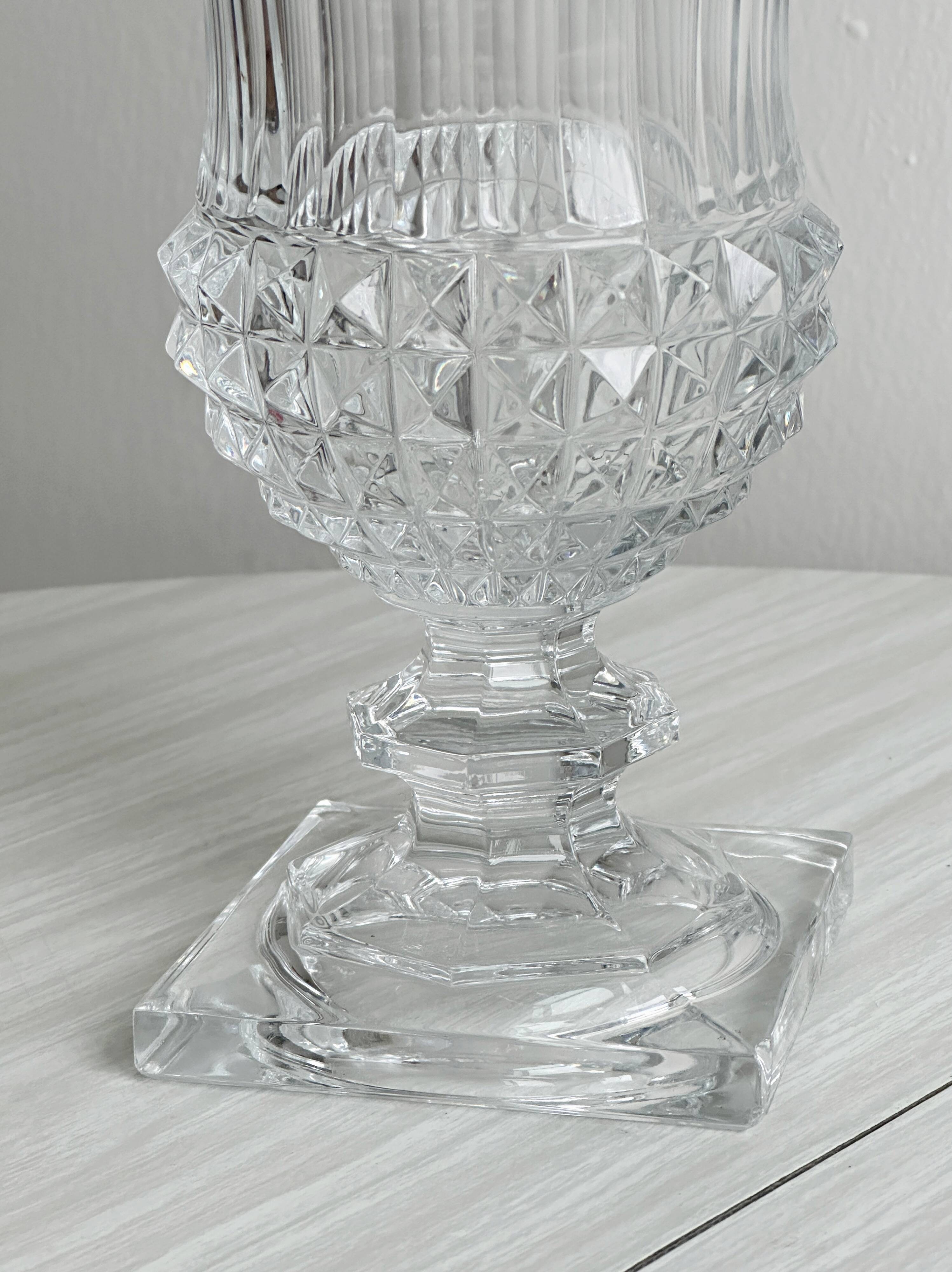 Antique thick glass vase on a pedestal.