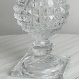 Antique thick glass vase on a pedestal.