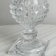 Antique thick glass vase on a pedestal.