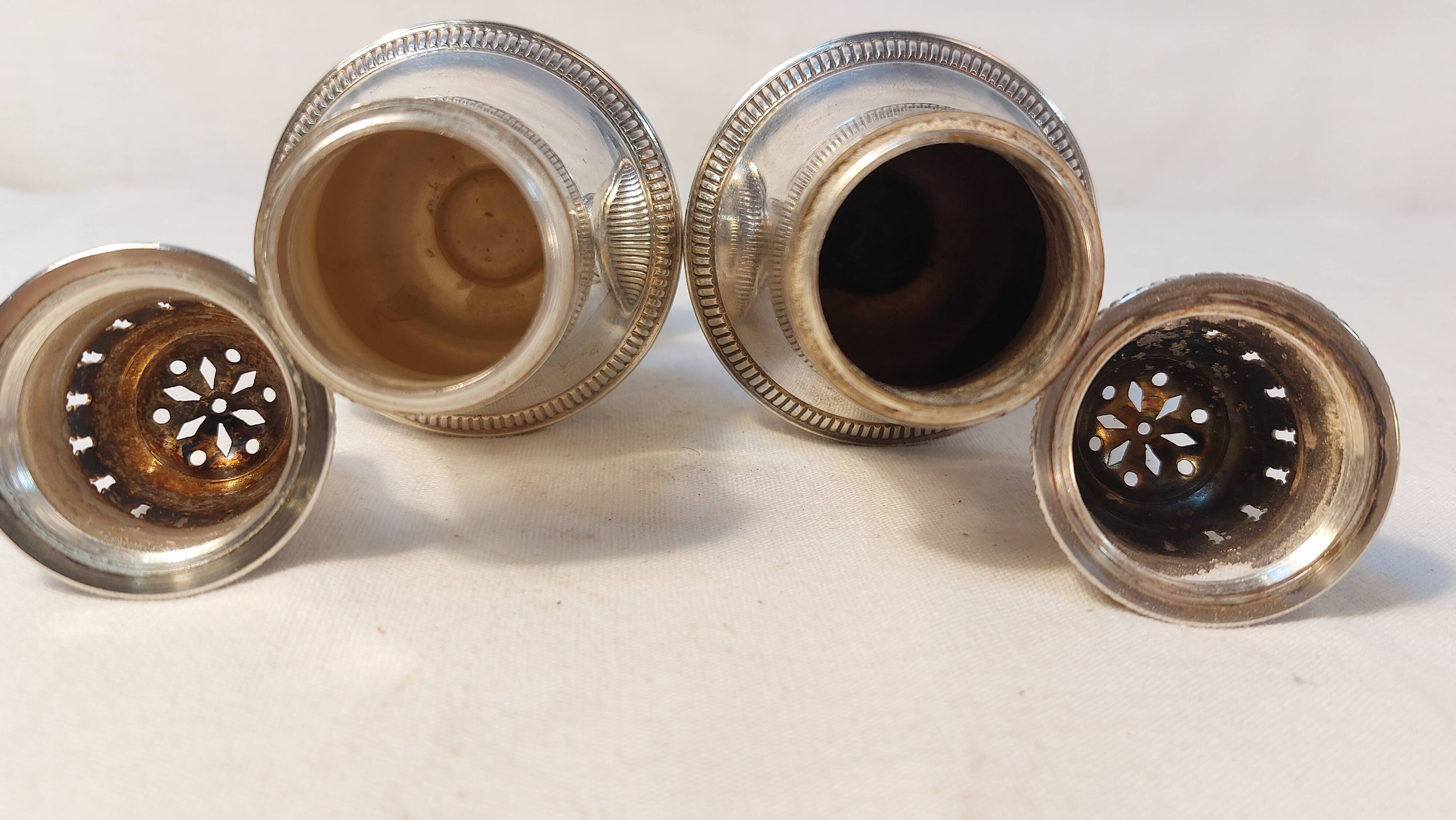 Set of two silver metal sprinklers