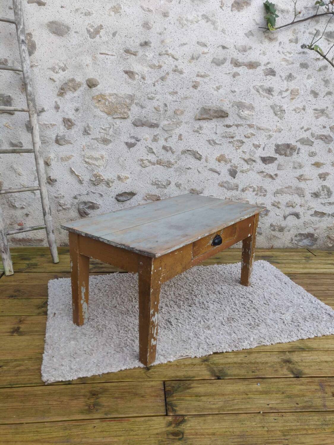 Patinated coffee table with a drawer